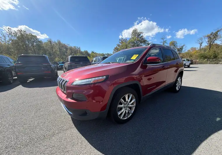 Red 2015 Jeep Cherokee in a car lot at pickup in Canonsburg, Pennsylvania