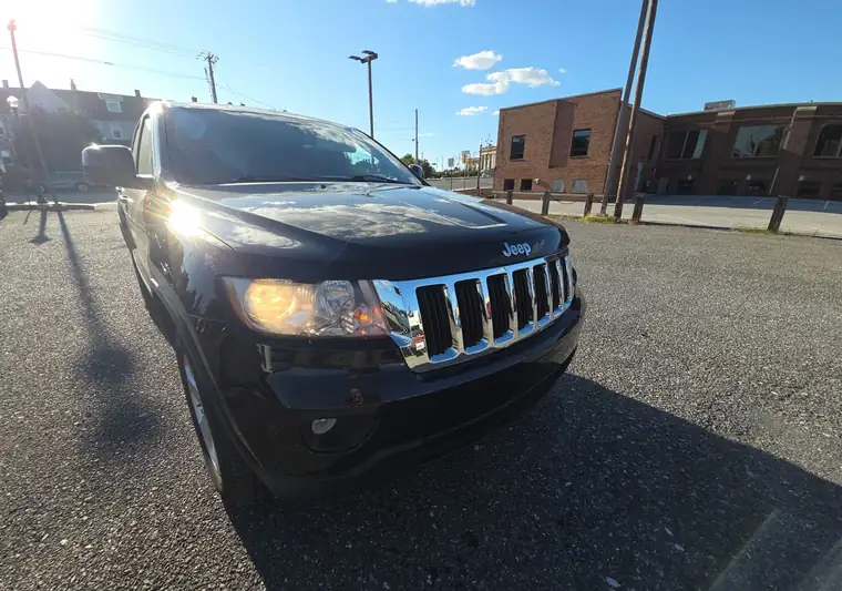 Black 2012 Jeep Grand Cherokee in a dealer lot at pickup in Lancaster, Pennsylvania