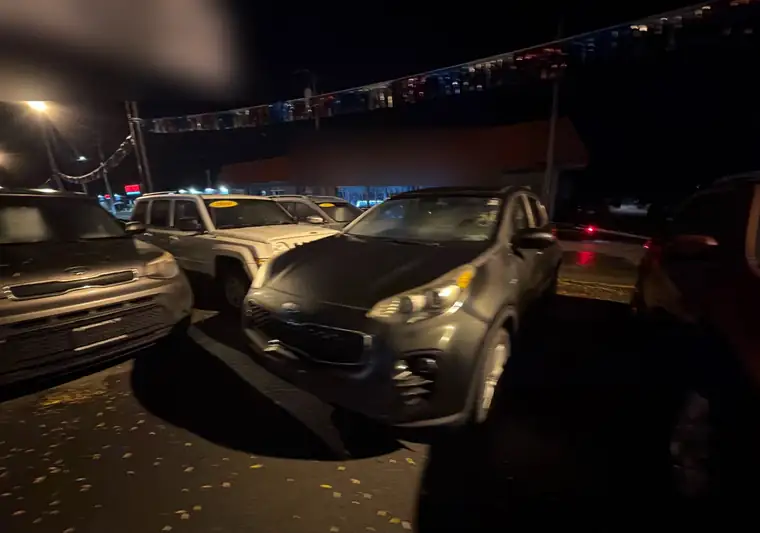 The same Kia Sportage in a dealer lot at night at delivery in Herkimer, New York