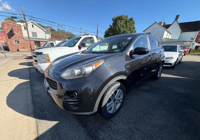 Dark gray 2017 Kia Sportage SUV in a car lot at pickup in Connellsville, Pennsylvania