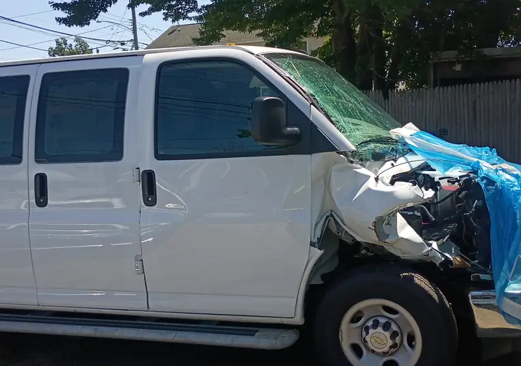 The same Express van at delivery in Milford, Connecticut with the damaged front corner and tarp visible