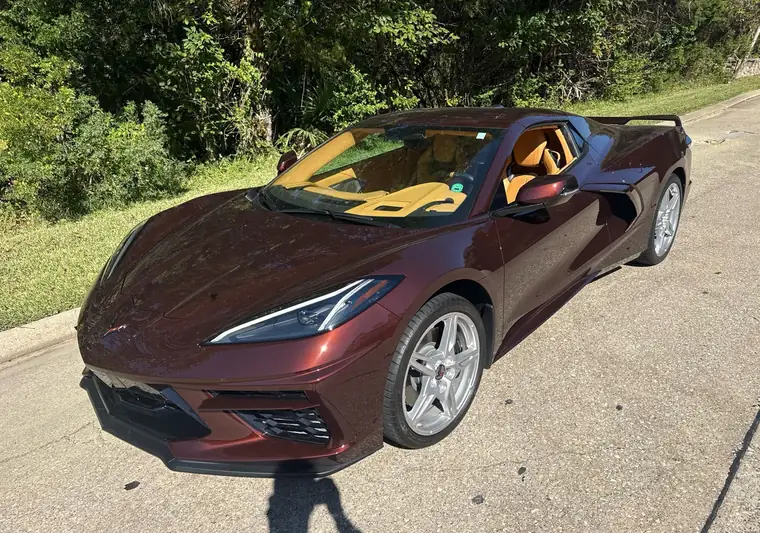 The same Corvette on a quiet street in daylight at delivery in Montgomery, Texas