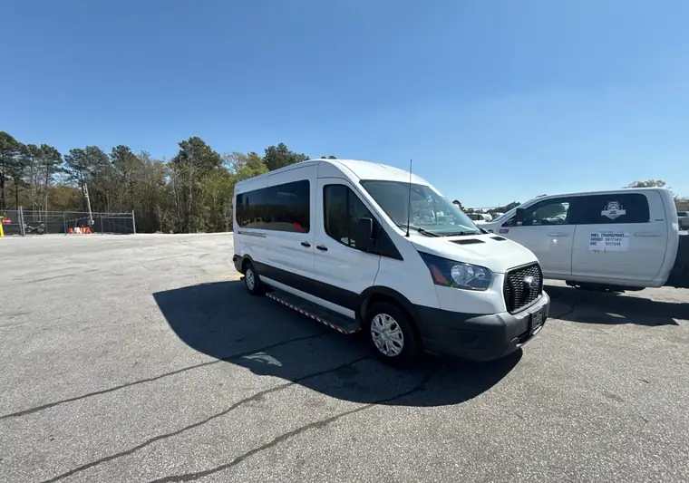 White Ford Transit passenger van at a yard at pickup in Lexington, South Carolina