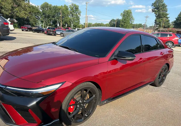 Red 2024 Hyundai Elantra sedan on a dealer lot at pickup in Greenville, South Carolina