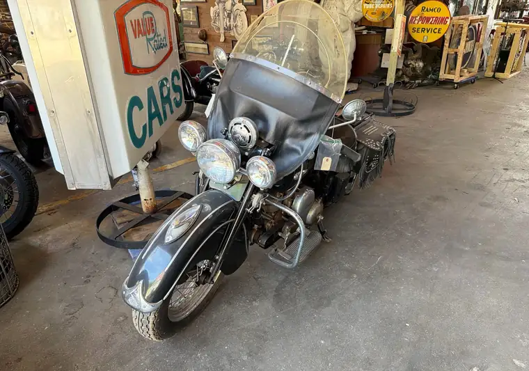 The same black Indian motorcycle parked in a warehouse at delivery in Davenport, Iowa