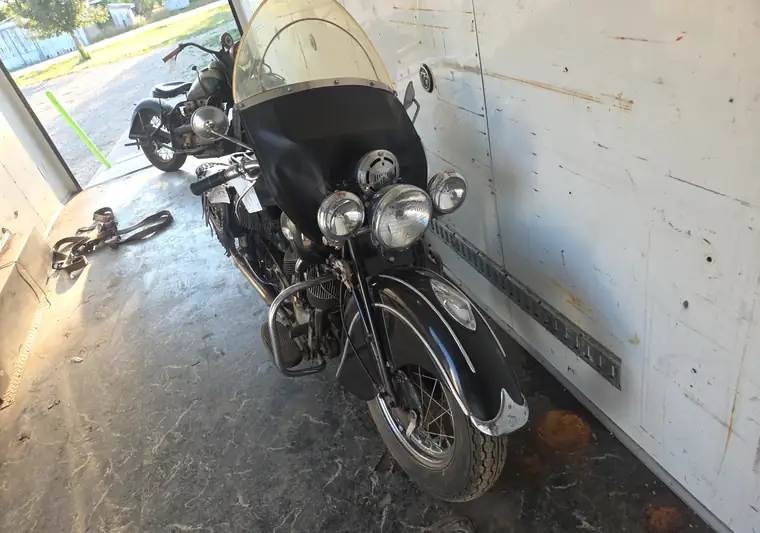 Black 1941 Indian motorcycle with a windshield and saddlebags loaded in an enclosed trailer at pickup in Onida, South Dakota