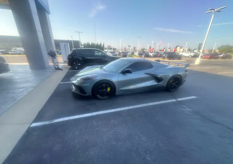 The same Corvette in a Chevrolet dealership parking lot at delivery in Anderson, Indiana