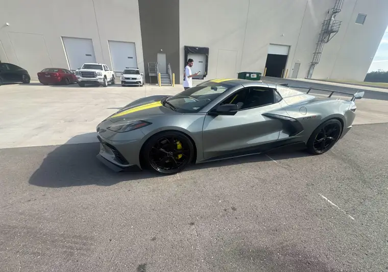 Gray 2022 Chevrolet Corvette with yellow stripes in a dealership lot at pickup in Lebanon, Tennessee