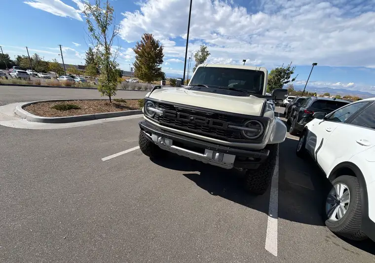 The same Ford Bronco Raptor in a dealership lot at delivery in Loveland, Colorado