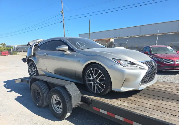 Gray 2015 Lexus RC 350 with rear damage on a trailer at an auction yard in Chattanooga, Tennessee