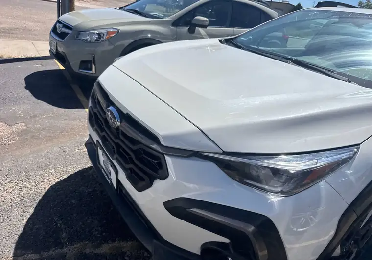 The same Subaru Crosstrek in a parking lot at delivery in the Denver area