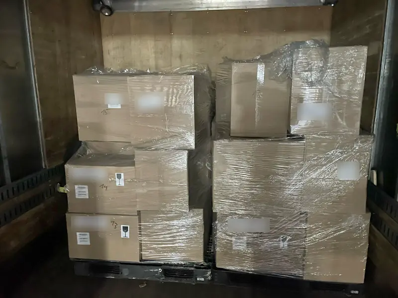 Wrapped pallets of boxed freight loaded and secured inside a box truck