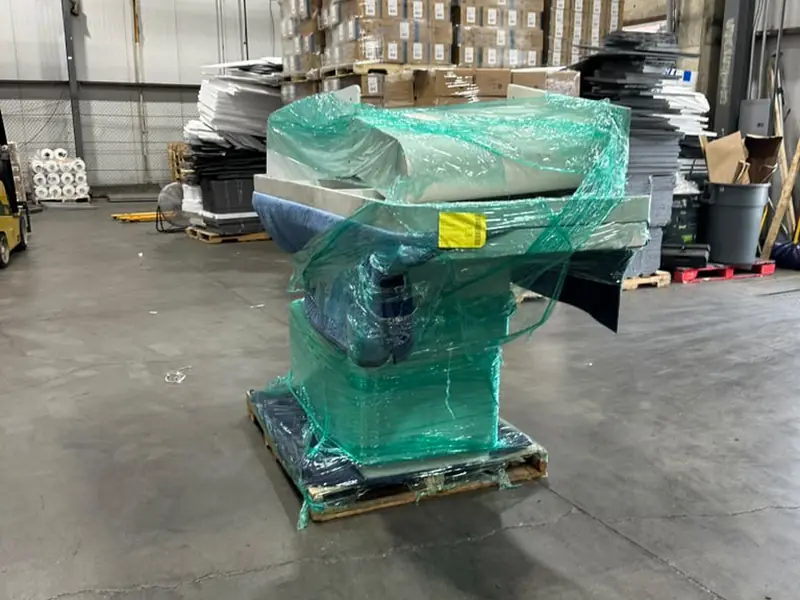 A wrapped pallet of freight waiting for pickup on a warehouse floor